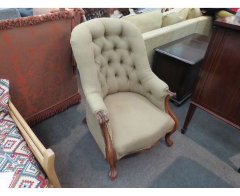 A Victorian button-back rosewood tub chair with scroll armrests and fore legs 