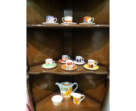 A Wedgwood Clarice Cliff harlequin coffee set consisting of coffee pot, sucrier, milk jug and eight cups and saucers 