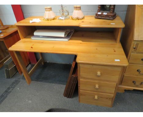 A modern pine desk, three frieze drawers, with shelf gallery back, 88cm high x 130cm wide x 78cm deep 