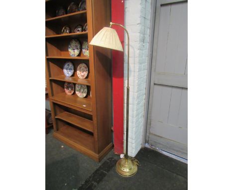A brass standard reading lamp with pleated shade 