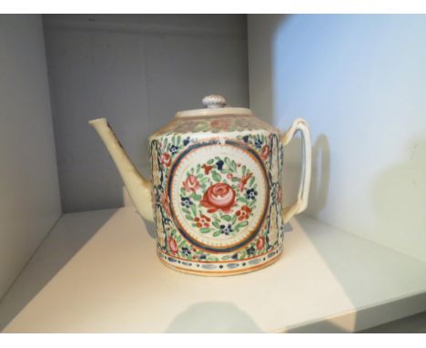 A Chinese export teapot decorated in famille rose palette depicting flowers 