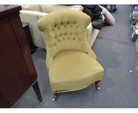 A Victorian button-back chair on ceramic castors 