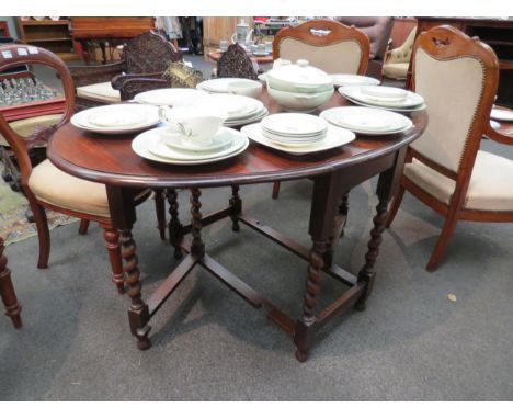 An oak gate-leg table on barley twist legs to stretcher 
