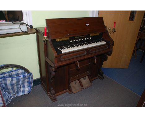 A Mason &amp; Hamlin Harmonium having brass candle sconces