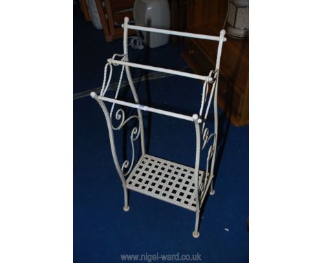 A lightweight metal towel rail with lower shelf.