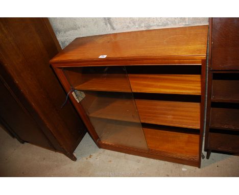 A glass fronted three shelf bookcase.