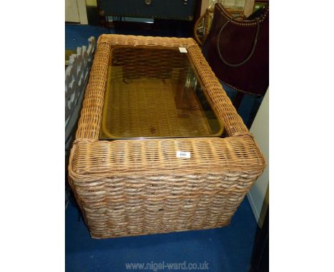 A glass top cane conservatory table with lower shelf, 38" x 22" x 18 1/2"