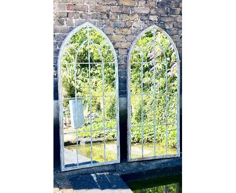 ARCHITECTURAL GARDEN WALL MIRRORS, a pair, aged metal frames, 160cm x 67cm. (2) 