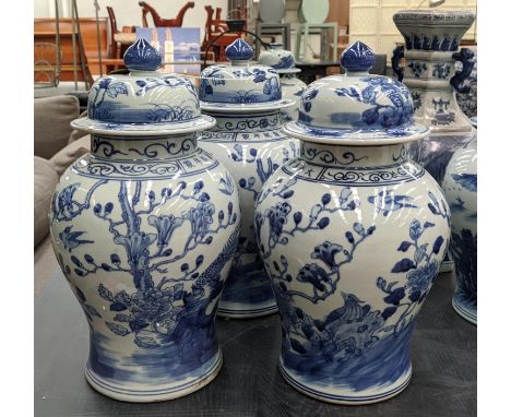 TEMPLE JARS, a set of three, Chinese export style, blue and white ceramic, cherry blossom decoration, 42cm H. (2) 