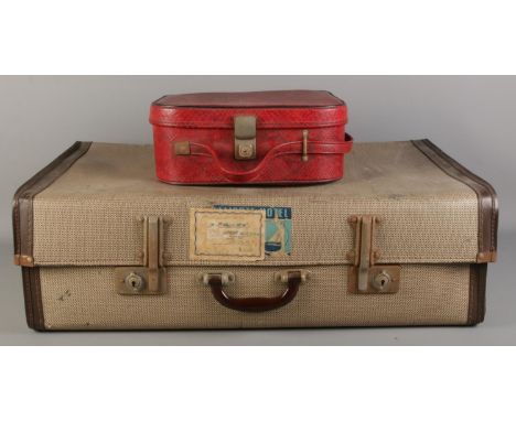A large vintage suitcase, together with a red faux leather vanity case (empty).  