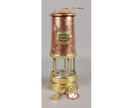 A Lamp &amp; Limelight company brass and copper miners lamp. Also includes keyring miniature and BACM badge.  