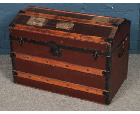 A dome top wooden bound trunk. (58cm x 76cm)  