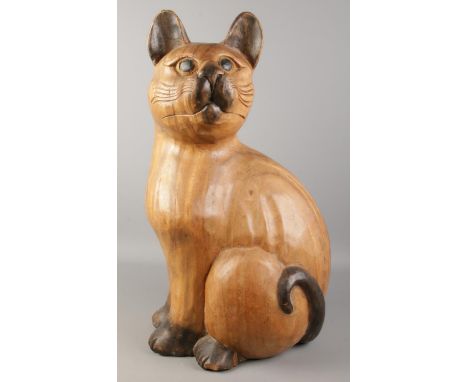 A large carved wooden model of a cat. Height 61cm.  