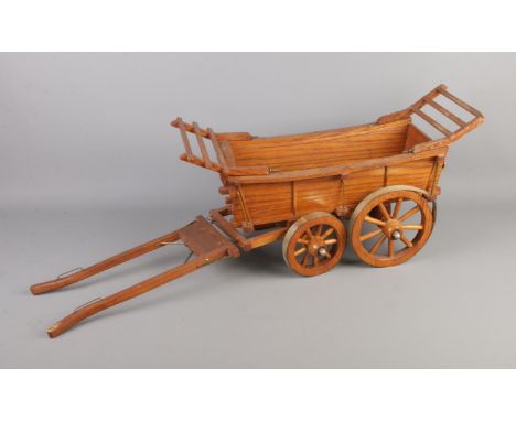 A wooden model hay cart. Approx. dimensions 81cm x 28cm.  