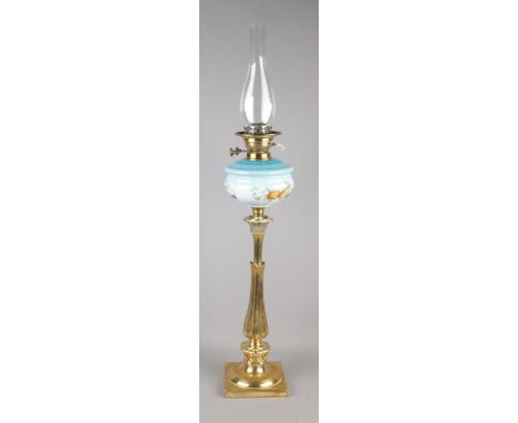 A brass column oil lamp featuring a painted glass reservoir with blue gradient and fruit still life decoration. Approx. 91cm 