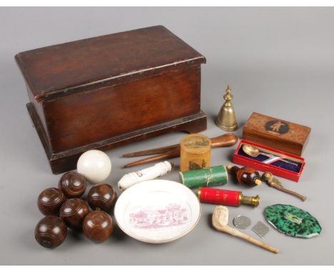 A mahogany box with contents of collectables. Includes carpet bowls, Mauchline ware box, compact, The Crystal Palace dish etc