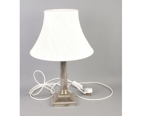 A silver plated Corinthian column table lamp with pleated cream shade.  