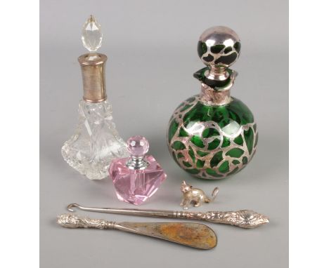 A collection of silver and white metal mounted items. Includes small silver model of a cat, button hook and shoe horn and sce