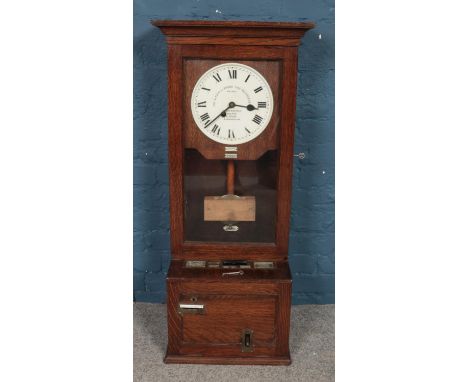 A vintage oak cased Gledhill-Brook Time Recorders Ltd clocking in machine.  
