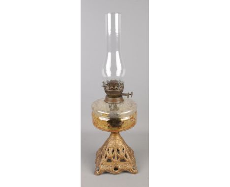A brass oil lamp with pierced base.  