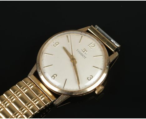 A Gents 9ct Gold Tissot manual wristwatch, with presentation case to the back, silvered dial and quarter numeral markers. On 