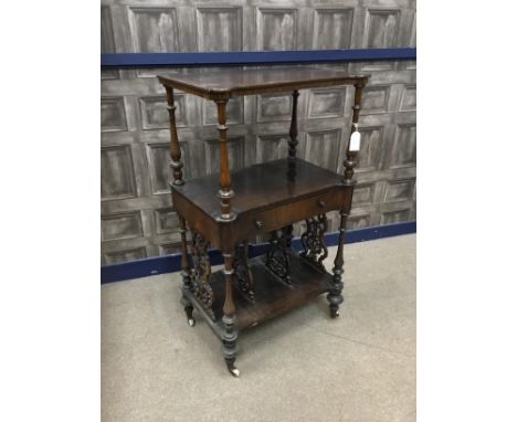 VICTORIAN ROSEWOOD CANTERBURY WHATNOT, with central drawer, fretted divisions below, within turned baluster uprights, on turn