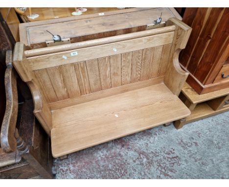 A pitch pine two seater church pew, width 105.5cm.