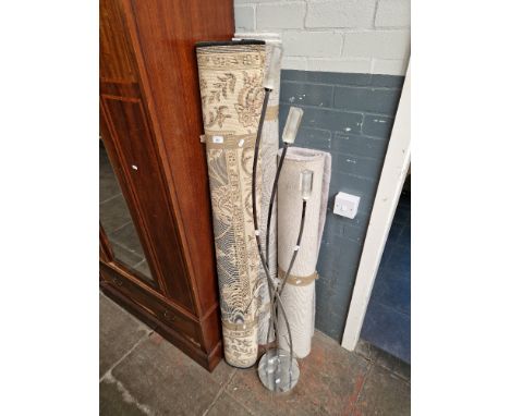 Three modern rugs and a chrome floor standing lamp.  