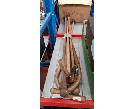 A bundle of vintage walking sticks, one with duck head handle.