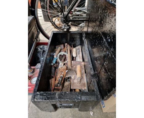 A wooden chest containing hand tools.  