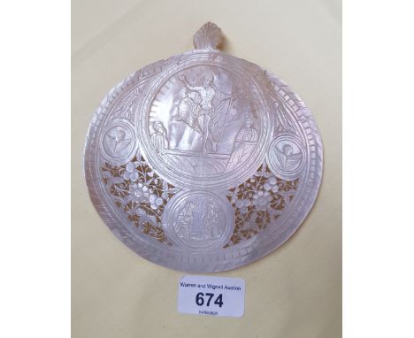 A carved and pierced mother of pearl shell depicting the resurrection of Jesus Christ.  