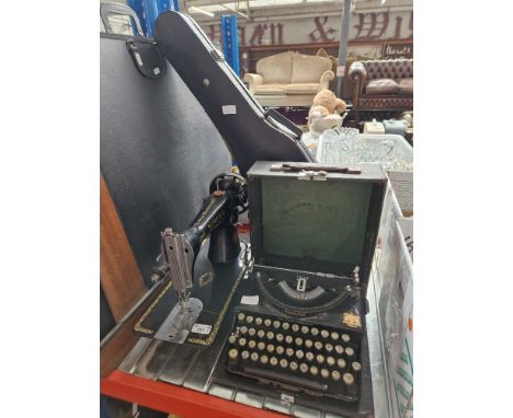 Assorted items comprising a student's violin, a vintage typewriter and a Singer sewing machine.