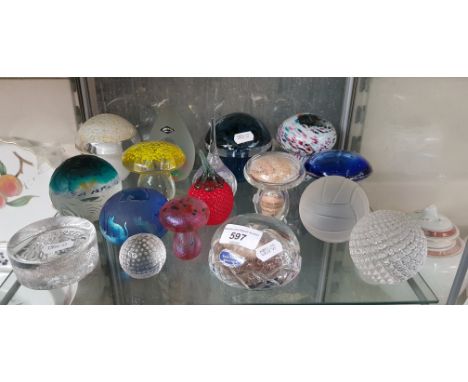A collection of 17 glass paperweights including Caithness Glass, Kosta Boda, Isle of Wight, Wedgwood, etc.