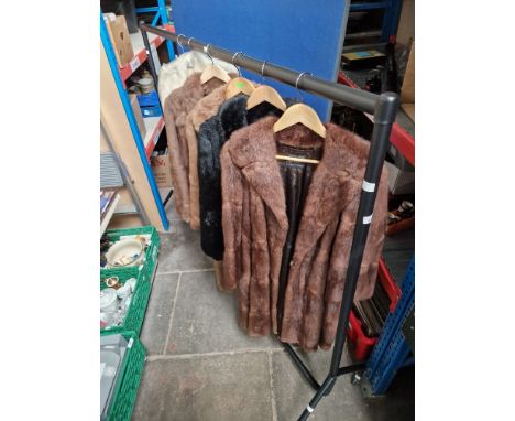 A clothes rail of vintage women's 50's &amp; 60's clothing containing 4 fur coats and a group of fur stoles and wraps
