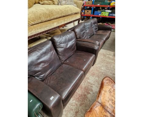 A brown leather three seater sofa and matching two seater sofa.  