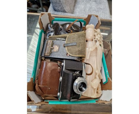 A No 2 Autographic folding Brownie camera, a GB-Kershaw 630 Vario folding camera, a wooden elephant, and a carved soapstone C