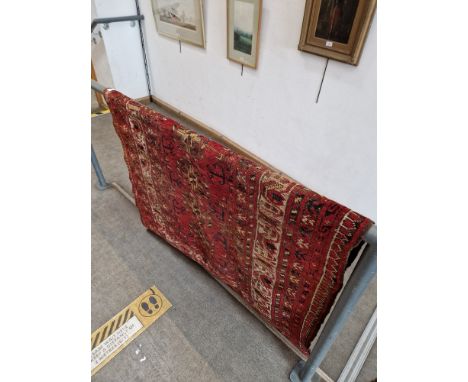 A vintage Middle Eastern wool carpet, red ground, 193cm x 119cm (approx).