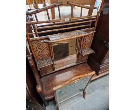 A bamboo and embossed leather overmantle mirror and a tapestry fire screen.  