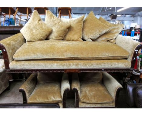 A carved mahogany framed three seater sofa and two matching armchairs, all with down filled cushions.