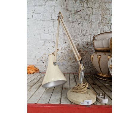 A cream anglepoise lamp  