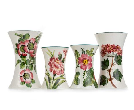WEMYSS, FOUR BEAKER VASES, each hand painted with flowers, one with impressed marks and stamped retailer mark for T. Goode &a