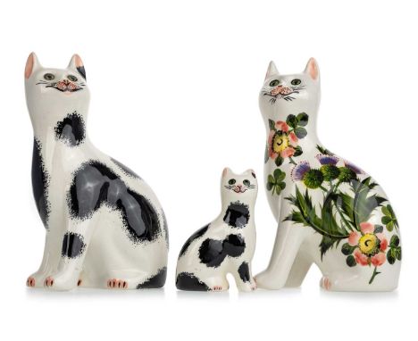 GRISELDA HILL, WEMYSS POTTERY THREE CATS one painted with thistles and flowers, the other two in black and whitethe tallest 1