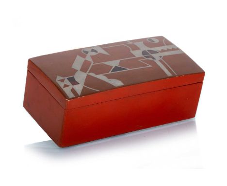 FRENCH RED LACQUERED OBLONG TRINKET BOX, IN THE MANNER OF JEAN DUNAND the hinged cover decorated with geometric pattern in si