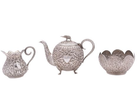 An Indian three-piece silver tea set, unmarked, early 20th century, of globular form, elephant finial with raised, chased and