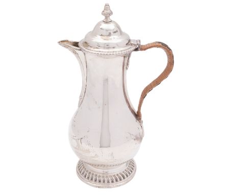 A George V silver hot water jug, Elkington & Co Ltd. Birmingham 1920, the domed hinge lid with cast finial gadrooned rim, bal