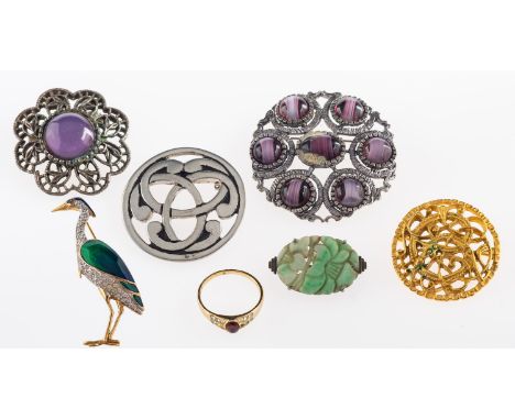 A small group of jewellery, to include: a carved jade brooch, 3.2cm wide; a ring; and five brooches 