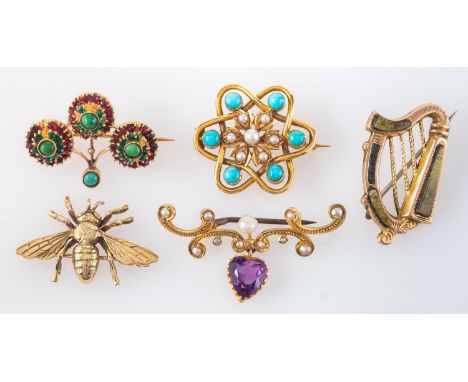 Five brooches, including inter alia a 9ct gold bee brooch; a Connemara marble harp brooch, stamped '9CT'; a heart-shaped amet