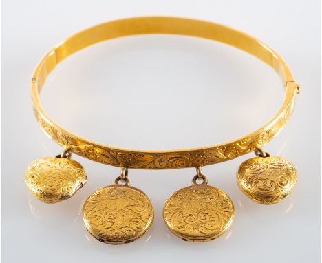 A hinged bangle, with engraved foliate decoration and four hinged locket pendants, three of which have glazed compartments, o