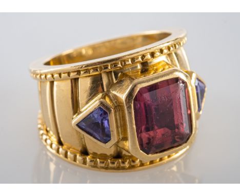 A Theo Fennell, 18ct gold, bombe ring, set with an octagonal step-cut pink tourmaline and two kite-shaped tanzanite, estimate