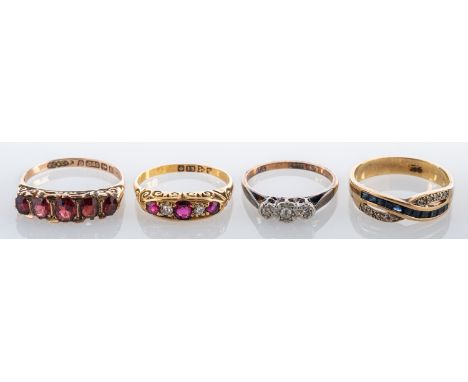 Four gem set rings, to include: a ruby and diamond ring, stamped 18, ring size O; a garnet ring; a diamond three stone ring; 